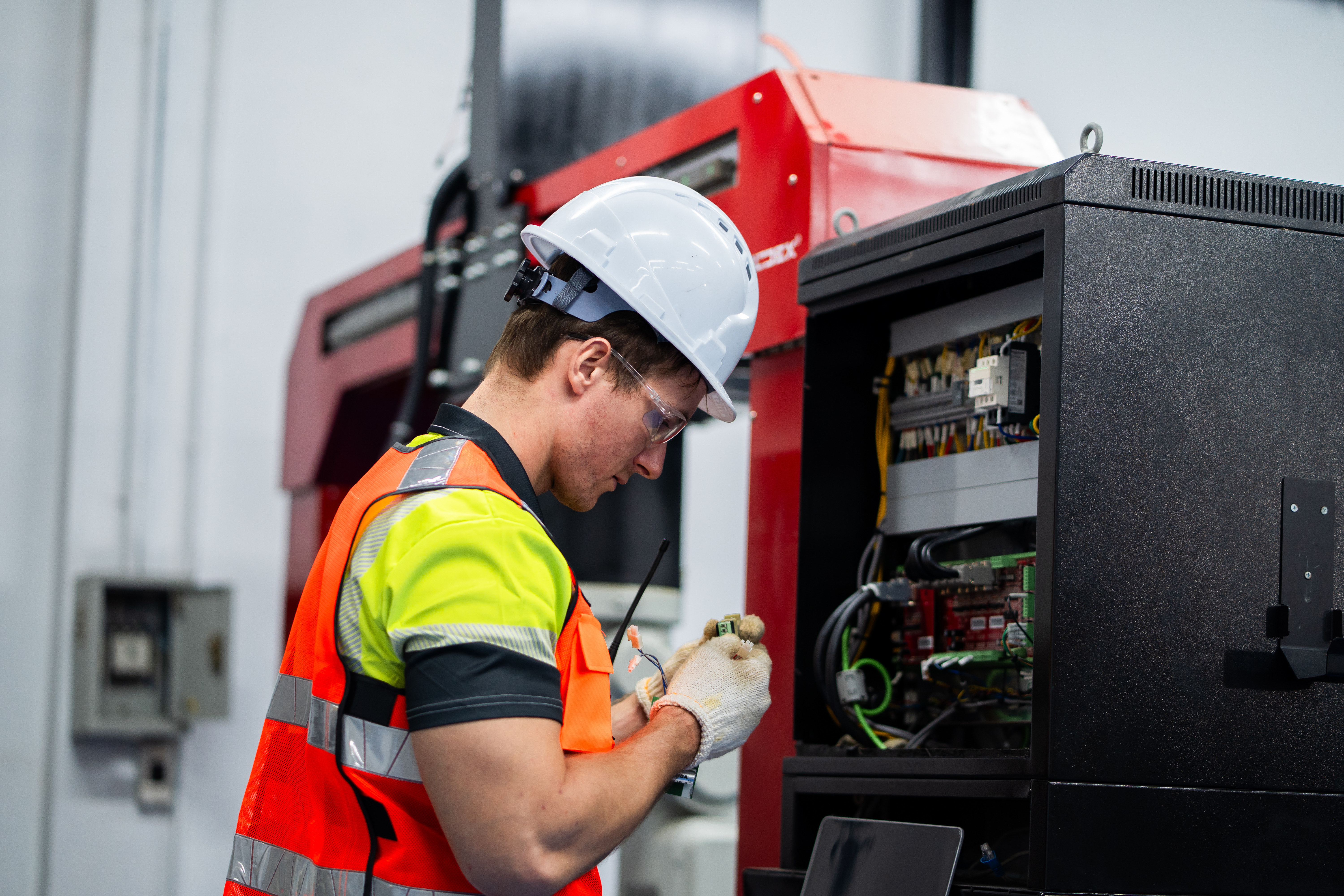 Technician repairing commercial plumbing pipe connection
